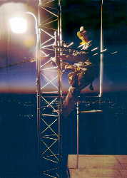 Dale, WB7FID, hanging off the TX tower just before sunrise.