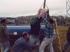 Don - N7YUQ, Bill - N1BR, and Daryl - AF7O drive the ground rod into the rock - small version