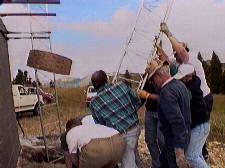 Setting one of the towers in its hole - small version