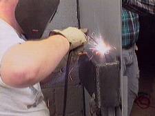 Chuck, WA7JOS, welding the lock box to the door - small version